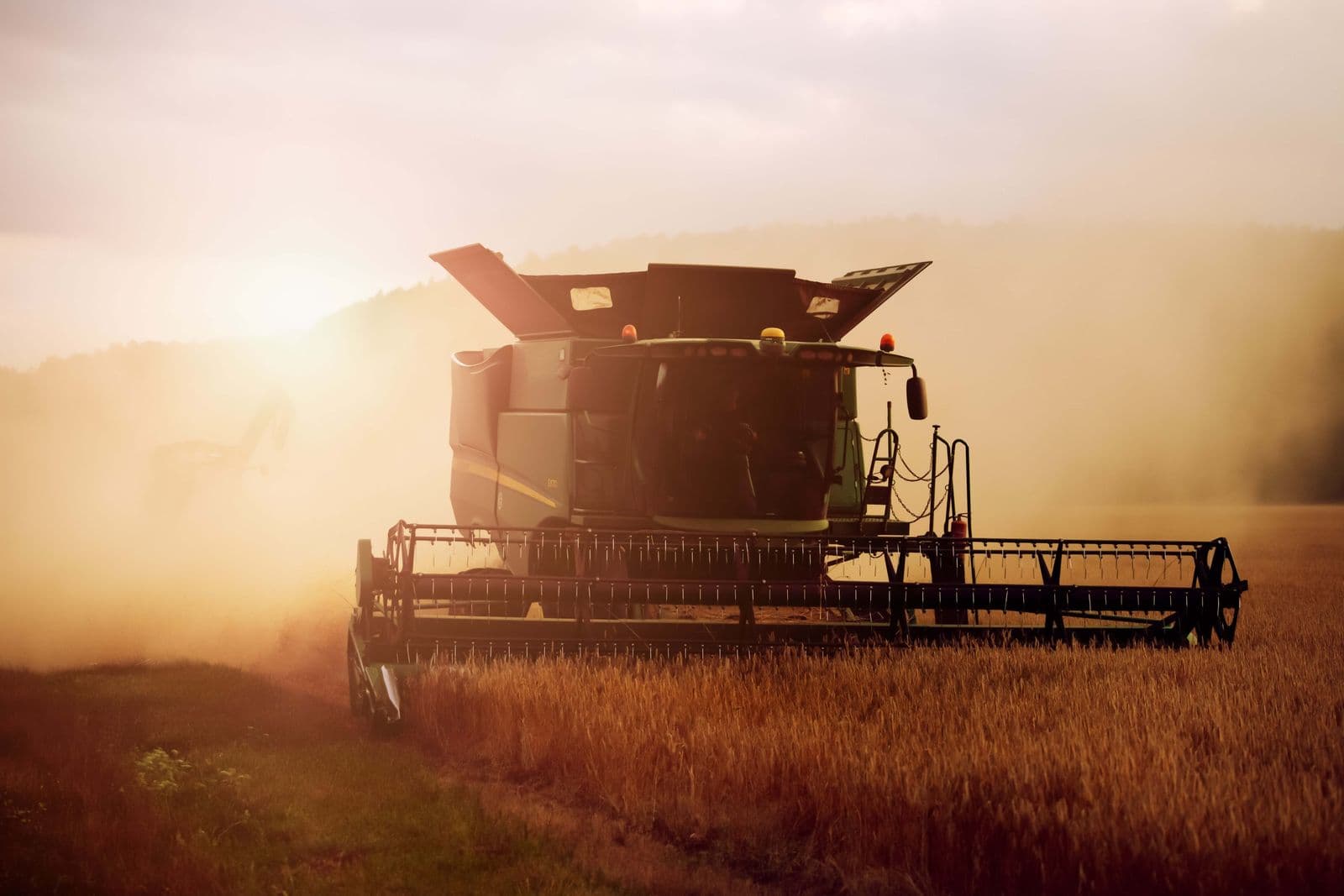 Combine harvester working in field